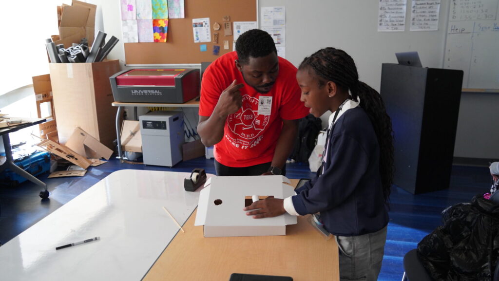 A TEK8 mentor helps a student at Metro Middle School