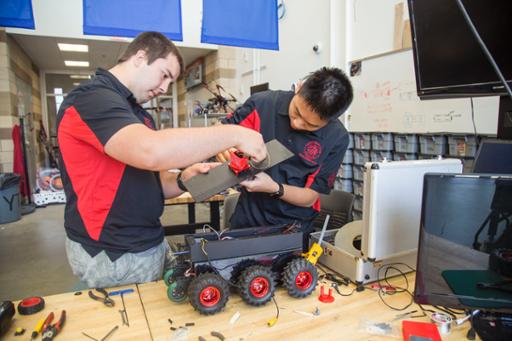 Mark working with his friend Peng Zhou from Design Lab Early College High School. They're making modifications to a "scout robot" built for bomb squads securing Cleveland during the 2016 Republican National Convention. To build the robot, students contacted the local bomb squad to refine the prototype. The robot was named "The Griffin" in honor of former team member Henry Griffin. Henry passed away in May 2016. He was a 3-year member of the team that built this robot at the Youth Technology Academy, a program of Cuyahoga Community College.